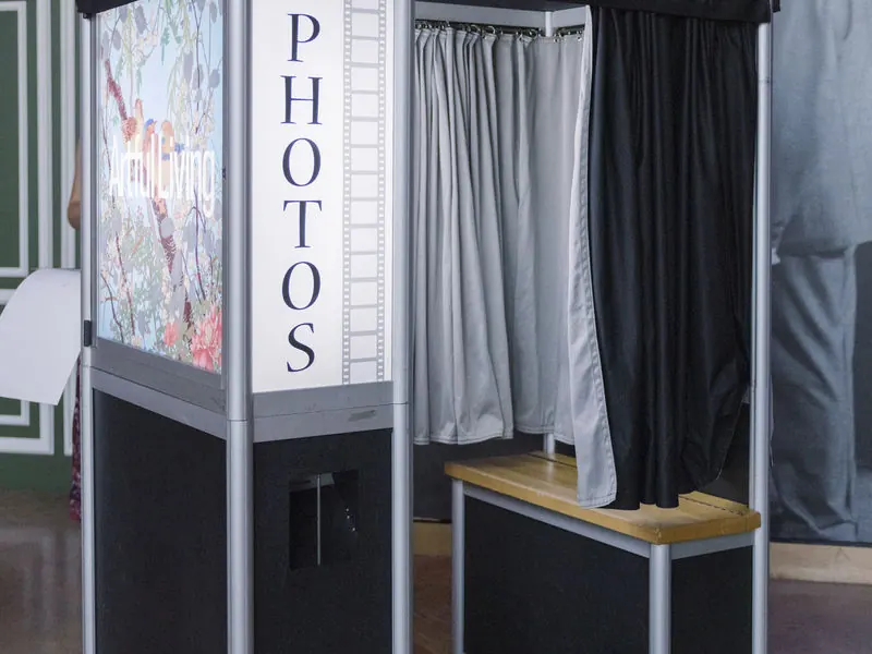 Classic enclosed photo booth with a curtain at a Minneapolis event
