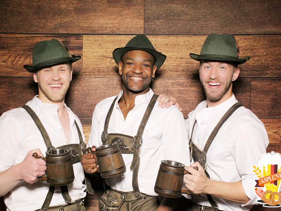 Coworkers in lederhosen at a company party photo booth