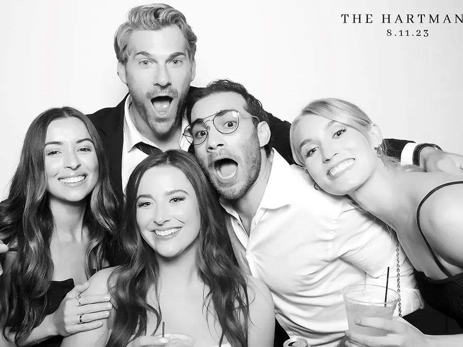Black and white glam photo booth photo of friends laughing