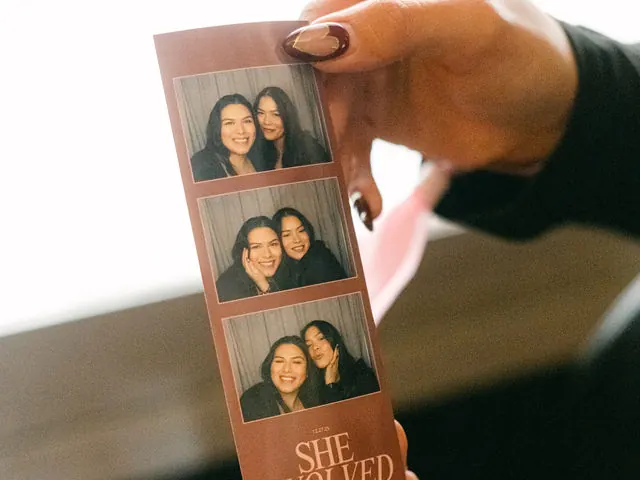 Guest holding a custom wedding photo strip